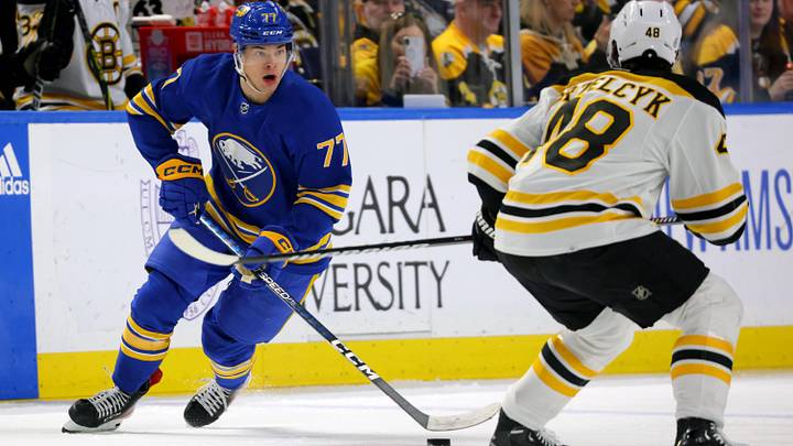 Mar 19, 2023; Buffalo, New York, USA;  Buffalo Sabres right wing JJ Peterka (77) skates with the puck as Boston Bruins defenseman Matt Grzelcyk (48) defends during the second period at KeyBank Center. Mandatory Credit: Timothy T. Ludwig-Imagn Images