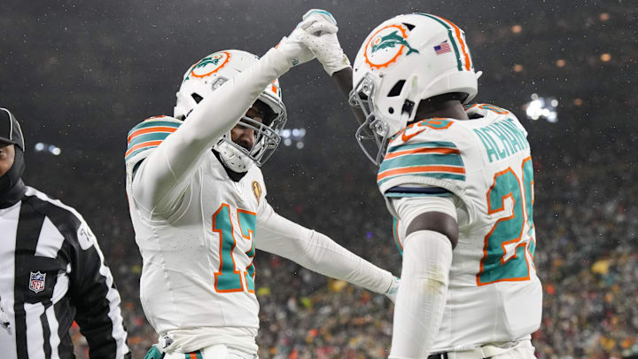 Miami Dolphins wide receiver Jaylen Waddle (17) celebrates with running back De'Von Achane (28) following a two-point conversion during the third quarter against the Green Bay Packers at Lambeau Field.