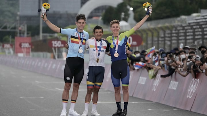 Jul 24, 2021; Shizuoka, Japan; From left, Wout van Aert (BEL), Richard Carapaz (ECU) and Tadej Pogacar (SLO) on the podium after the Men's Road Race during the Tokyo 2020 Olympic Summer Games at Fuji Speedway. Carapaz won gold, van Aert won silver, and Pogacar won bronze. Mandatory Credit: Andrew P. Scott-USA TODAY Network