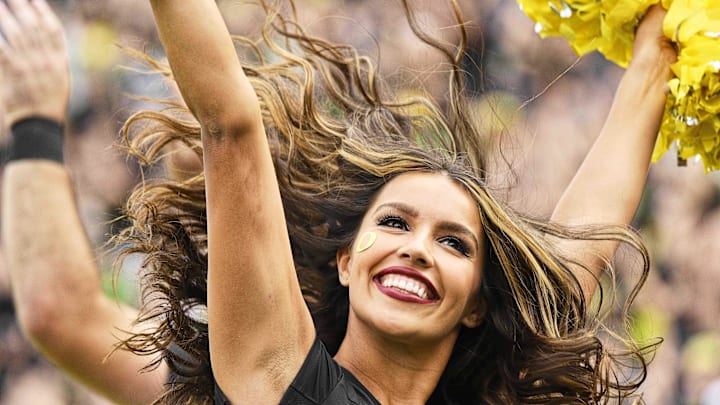 Sep 17, 2022; Eugene, Oregon, USA; An Oregon Ducks cheerleader leads a cheer during a time out during the second half against the Brigham Young Cougars at Autzen Stadium. Oregon won the game 41-20. Mandatory Credit: Troy Wayrynen-Imagn Images