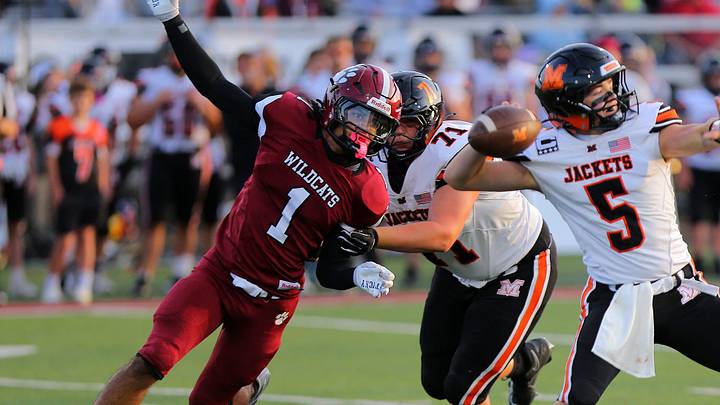 Newark's Roy Price Jr. pressures Mount Vernon's Mason Richards during the Wildcats' 24-7 home loss at White Field on Aug. 29, 2025.