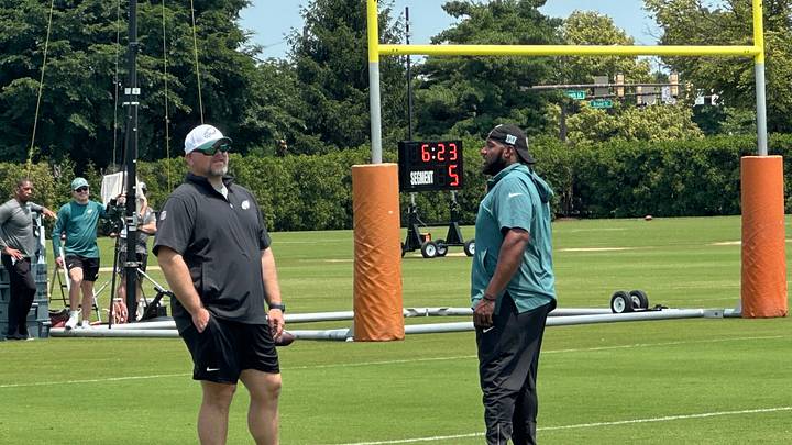 Joe Douglas chats with assistant OL coach Greg Austin during OTAs.