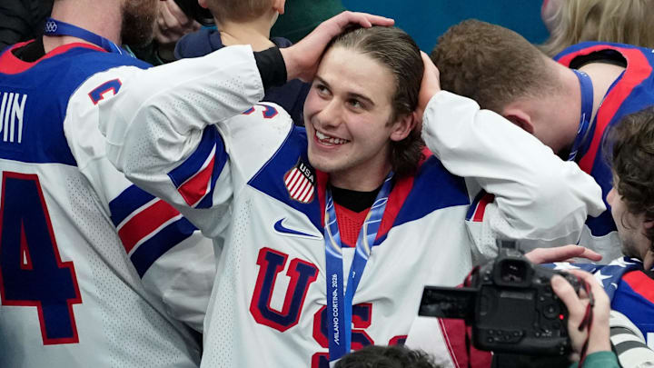Feb 22, 2026; Milan, Italy; Jack Hughes of the United States celebrates after winning the men's ice hockey gold medal game during the Milano Cortina 2026 Olympic Winter Games at Milano Santagiulia Ice Hockey Arena. Mandatory Credit: James Lang-Imagn Images