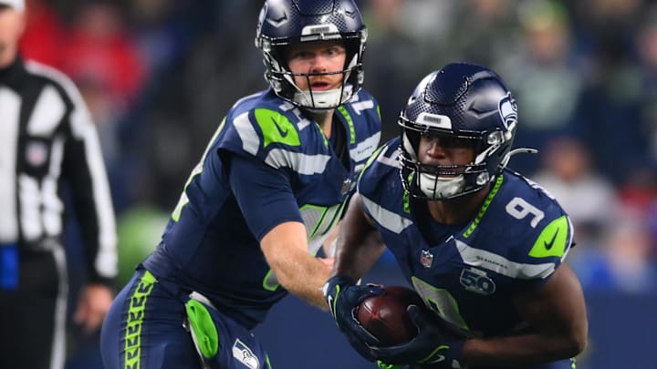 Oct 20, 2025; Seattle, Washington, USA; Seattle Seahawks quarterback Sam Darnold (14) hands the ball off to Seattle Seahawks running back Kenneth Walker III (9) during the third quarter against the Houston Texans at Lumen Field. Mandatory Credit: Steven Bisig-Imagn Images