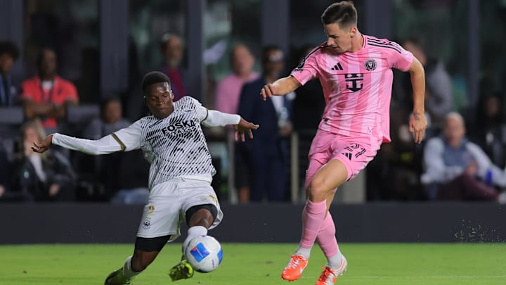 Mar 6, 2025; Ft. Lauderdale, Florida, USA; Cavalier FC midfielder Christopher Ainsworth, left, defends against Inter Miami CF forward Tadeo Allende during the first half at Chase Stadium. Mandatory Credit: Sam Navarro-Imagn Images