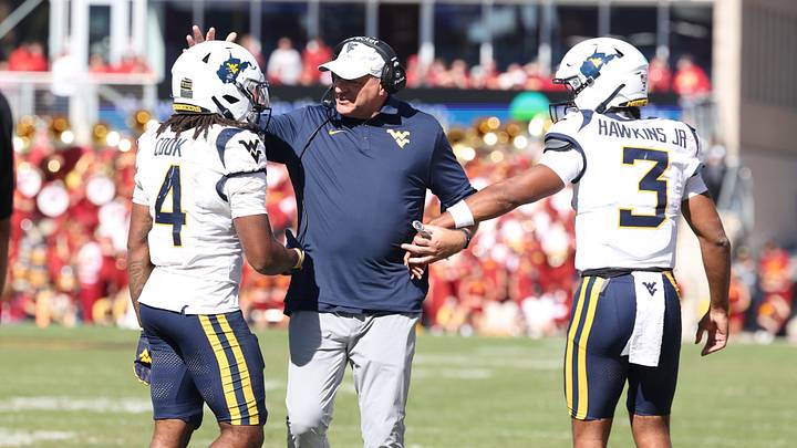 Oct 3, 2026; Ames, Iowa, USA; West Virginia Mountaineers head coach Rich Rodriguez celebrates with West Virginia Mountaineers quarterback Michael Hawkins Jr. (3) and West Virginia Mountaineers running back Cam Cook (4) after the touchdown against the Iowa State Cyclones during the second half at Jack Trice Stadium. Mandatory Credit: Reese Strickland-Imagn Images Oct 3, 2026; Ames, Iowa, USA; West Virginia Mountaineers head coach Rich Rodriguez celebrates with West Virginia Mountaineers quarterback Michael Hawkins Jr. (3) and West Virginia Mountaineers running back Cam Cook (4) after the touchdown against the Iowa State Cyclones during the second half at Jack Trice Stadium. Mandatory Credit: Reese Strickland-Imagn Images