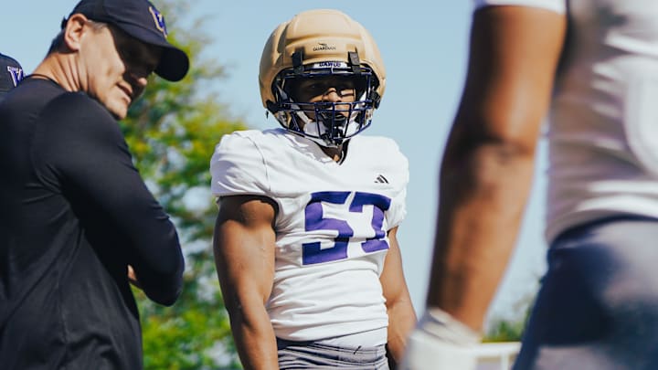 Anthony Ward stands with linebackers coach Brian Odom at practice.