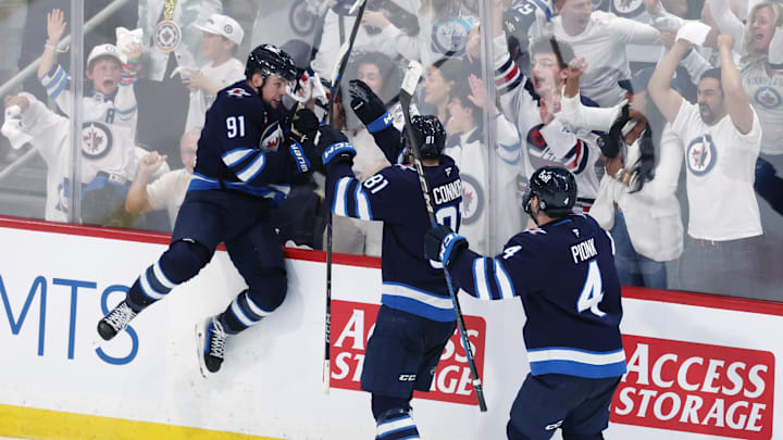 May 4, 2025; Winnipeg, Manitoba, CAN; Winnipeg Jets center Cole Perfetti (91) celebrates after his goal against the St. Louis Blues with teammates left wing Kyle Connor (81) and defenseman Neal Pionk (4) in the third period in game seven of the first round of the 2025 Stanley Cup Playoffs at Canada Life Centre. Mandatory Credit: James Carey Lauder-Imagn Images