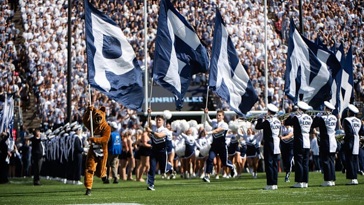 The Penn State Nittany Lion mascot leads the way as the team takes the field for an NCAA football game against Nevada. The Penn State Nittany Lion mascot leads the way as the team takes the field for an NCAA football game against Nevada.