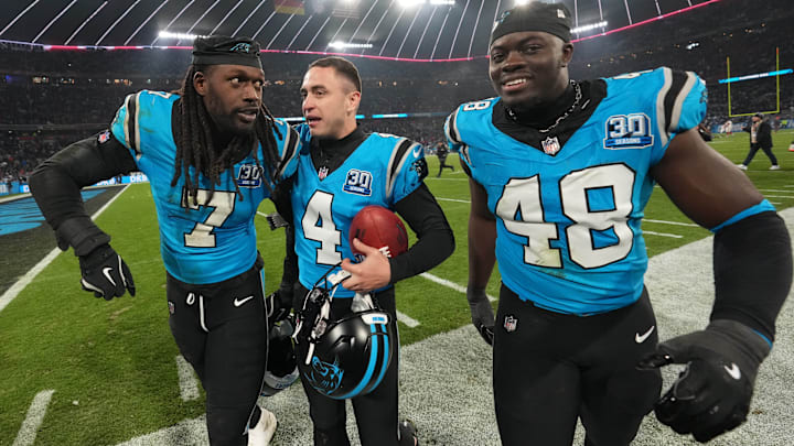 Nov 10, 2024; Munich, Germany; Carolina Panthers place kicker Eddy Pineiro (4) celebrates with linebacker Thomas Incoom (48) and linebacker Jadeveon Clowney (7) after kicking a 36-yard field goal in overtime against the New York Giants during the 2024 NFL Munich Game at Allianz Arena.