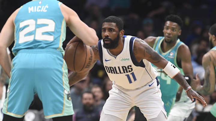 Apr 9, 2024; Charlotte, North Carolina, USA;  Dallas Mavericks guard Kyrie Irving (11) defends