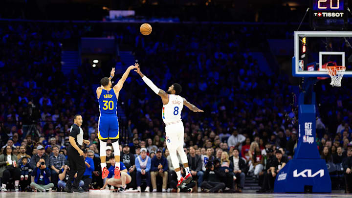 Mar 1, 2025; Philadelphia, Pennsylvania, USA; Golden State Warriors guard Stephen Curry (30) shoots in front of Philadelphia 76ers forward Paul George (8) during the second quarter at Wells Fargo Center. Mandatory Credit: Bill Streicher-Imagn Images