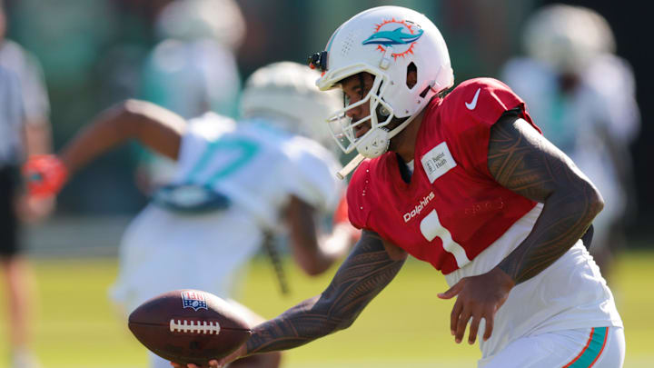 Miami Dolphins quarterback Tua Tagovailoa (1) practices handing off the football during training camp at Baptist Health Training Complex. 