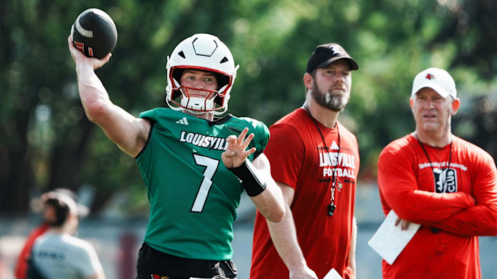 U of L QB Miller Moss (7) passes during practice as OC Brian Brohm and head coach Jeff Brohm, right, watch on the practice field at Cardinal Stadium in Louisville, Ky. on July 30, 2025. U of L QB Miller Moss (7) passes during practice as OC Brian Brohm and head coach Jeff Brohm, right, watch on the practice field at Cardinal Stadium in Louisville, Ky. on July 30, 2025.