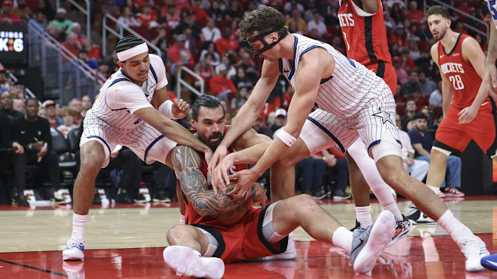 Nov 16, 2025; Houston, Texas, USA; Orlando Magic guard Anthony Black (0) and forward Franz Wagner (22) attempt to get the ball away from Houston Rockets center Steven Adams (12) during the second quarter at Toyota Center. Mandatory Credit: Troy Taormina-Imagn Images Nov 16, 2025; Houston, Texas, USA; Orlando Magic guard Anthony Black (0) and forward Franz Wagner (22) attempt to get the ball away from Houston Rockets center Steven Adams (12) during the second quarter at Toyota Center. Mandatory Credit: Troy Taormina-Imagn Images