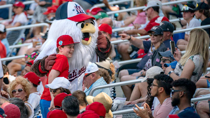 Fans pose for photos at Washington Nationals and St. Louis Cardinals spring training game at the Ballpark of the Palm Beaches in West Palm Beach, Florida on March 4, 2023.