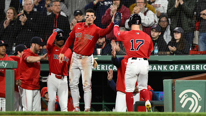 Boston, Massachusetts, USA; Boston Red Sox left fielder Tyler O'Neill (17) high-fives center fielder Jarren Duran (16) after scoring a run against the Minnesota Twins during the fourth inning at Fenway Park.