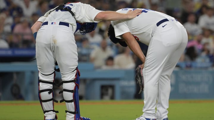 Aug 6, 2024; Los Angeles, California, USA; Los Angeles Dodgers catcher Will Smith (16) checks on relief pitcher Brusdar Graterol (41) the sixth inning after a hamstring injury against the Philadelphia Phillies at Dodger Stadium. Mandatory Credit: Jayne Kamin-Oncea-USA TODAY Sports Aug 6, 2024; Los Angeles, California, USA; Los Angeles Dodgers catcher Will Smith (16) checks on relief pitcher Brusdar Graterol (41) the sixth inning after a hamstring injury against the Philadelphia Phillies at Dodger Stadium. Mandatory Credit: Jayne Kamin-Oncea-USA TODAY Sports