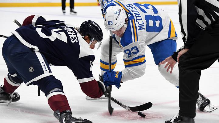 Oct 3, 2026; Denver, Colorado, USA; Colorado Avalanche right winger T.J. Hughes (13) faces off against St. Louis Blues center Mason McTavish (83) in the first period at Ball Arena. Mandatory Credit: Christopher Hanewinckel-Imagn Images
