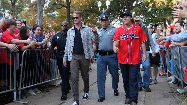 Nov 15, 2025; Oxford, Mississippi, USA; Mississippi Rebels head coach Lane Kiffin and comedian Theo Von make their way down the Walk of Champion to Vaught-Hemingway Stadium prior to the game against the Florida Gators. Mandatory Credit: Petre Thomas-Imagn Images