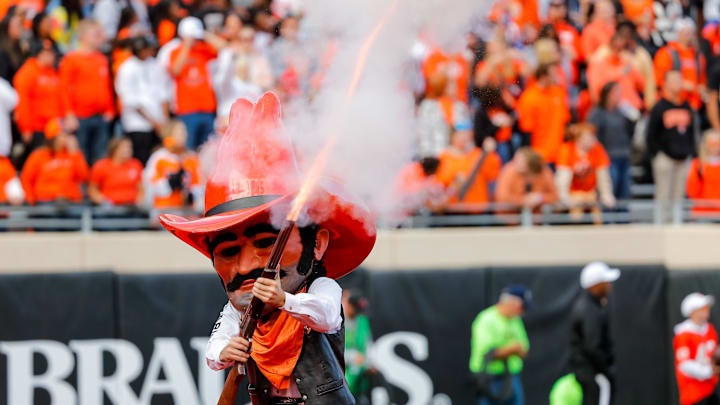 Oct 14, 2023; Stillwater, Oklahoma, USA; Oklahoma State Cowboys mascot Pistol Pete shoots a shotgun during a game between Oklahoma State and Kansas at Boone Pickens Stadium. Mandatory Credit: Nathan J. Fish-Imagn Images