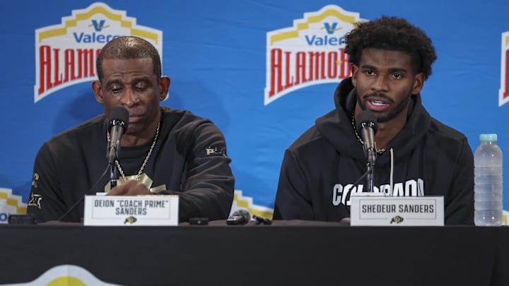 Dec 28, 2024; San Antonio, TX, USA; Colorado Buffaloes head coach Deion Sanders and quarterback Shedeur Sanders (2) talk with the media after the game against the Brigham Young Cougars at Alamodome. Dec 28, 2024; San Antonio, TX, USA; Colorado Buffaloes head coach Deion Sanders and quarterback Shedeur Sanders (2) talk with the media after the game against the Brigham Young Cougars at Alamodome.