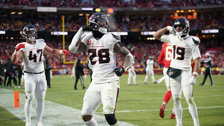 Jan 18, 2025; Kansas City, Missouri, USA; Houston Texans running back Joe Mixon (28) celebrates with fullback Andrew Beck (47) and wide receiver Xavier Hutchinson (19) after scoring a touchdown against the Kansas City Chiefs during the third quarter of a 2025 AFC divisional round game at GEHA Field at Arrowhead Stadium. Mandatory Credit: Denny Medley-Imagn Images