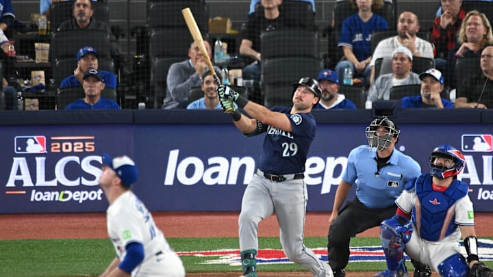 Oct 20, 2025; Toronto, Ontario, CAN; Seattle Mariners catcher Cal Raleigh (29) hits a solo home run against the Toronto Blue Jays in the fifth inning during game seven of the ALCS round for the 2025 MLB playoffs at Rogers Centre. Mandatory Credit: Dan Hamilton-Imagn Images