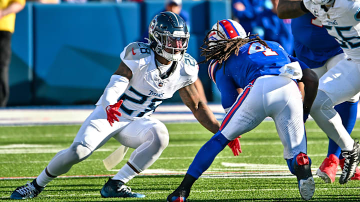 Oct 20, 2024; Orchard Park, New York, USA; Tennessee Titans safety Quandre Diggs (28) looks to make a tackle on Buffalo Bills running back James Cook (4) in the fourth quarter at Highmark Stadium. Mandatory Credit: Mark Konezny-Imagn Images