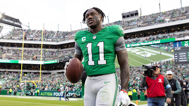 Dec 29, 2024; Philadelphia, Pennsylvania, USA; Philadelphia Eagles wide receiver A.J. Brown (11) carries his touchdown ball back to quarterback Tanner McKee (not pictured) during the third quarter against the Dallas Cowboys at Lincoln Financial Field. Mandatory Credit: Bill Streicher-Imagn Images