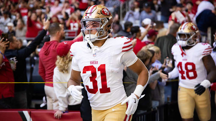 Jan 5, 2025; Glendale, Arizona, USA; San Francisco 49ers running back Isaac Guerendo (31) against the Arizona Cardinals at State Farm Stadium. Mandatory Credit: Mark J. Rebilas-Imagn Images