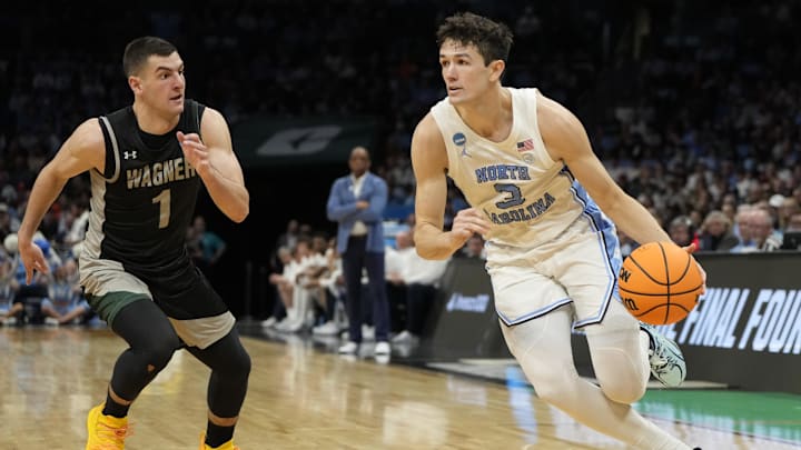 March 21, 2024, Charlotte, NC, USA; North Carolina Tar Heels guard Cormac Ryan (3) drives against Wagner Seahawks guard Javier Ezquerra (1) in the first round of the 2024 NCAA Tournament at the Spectrum Center. 