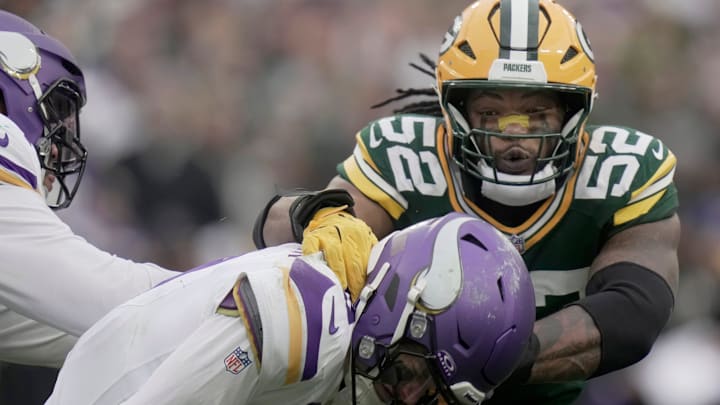 Minnesota Vikings' J.J. McCarthy (9) evades a sack by Green Bay Packers defensive end Rashan Gary (52) during the fourth quarter of their game Sunday, November 23, 2025 at Lambeau Field in Green Bay, Wisconsin. The Green Bay Packers beat the Minnesota Vikings 23-6.