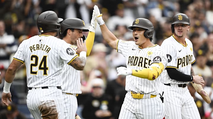 Jun 8, 2024; San Diego, California, USA; San Diego Padres shortstop Ha-Seong Kim (7), center-right, is congratulated by David Peralta (24), left, Kyle Higashioka (20), center-left, and Jackson Merrill (3) after hitting a three-run home run during the second inning against the Arizona Diamondbacks at Petco Park. Mandatory Credit: Denis Poroy-Imagn Images at Petco Park. Jun 8, 2024; San Diego, California, USA; San Diego Padres shortstop Ha-Seong Kim (7), center-right, is congratulated by David Peralta (24), left, Kyle Higashioka (20), center-left, and Jackson Merrill (3) after hitting a three-run home run during the second inning against the Arizona Diamondbacks at Petco Park. Mandatory Credit: Denis Poroy-Imagn Images at Petco Park.
