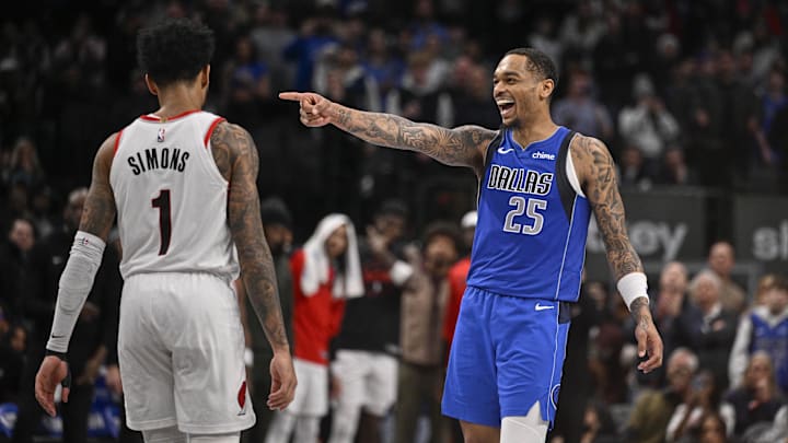Jan 9, 2025; Dallas, Texas, USA; Dallas Mavericks forward P.J. Washington (25) laughs and points to his teammates as Portland Trail Blazers guard Anfernee Simons (1) walks back up the court during the second half at the American Airlines Center. Mandatory Credit: Jerome Miron-Imagn Images