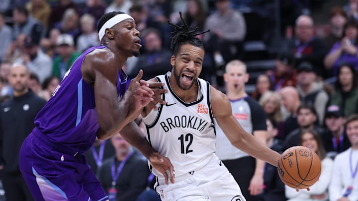 Jan 12, 2025; Salt Lake City, Utah, USA; Brooklyn Nets forward Tosan Evbuomwan (12) drives to the basket against Utah Jazz center Oscar Tshiebwe (34) during the second quarter at Delta Center. Mandatory Credit: Rob Gray-Imagn Images