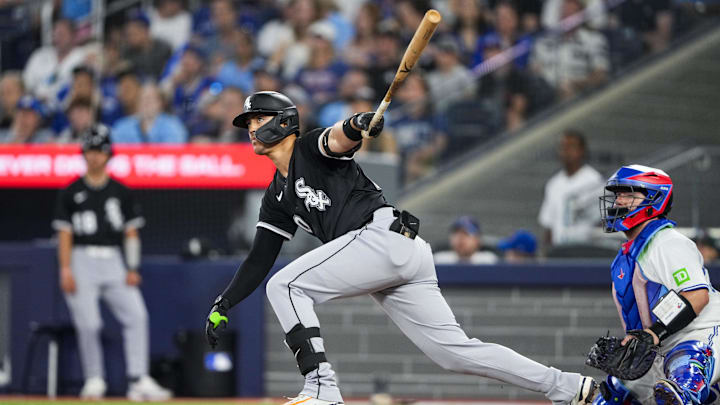 Jun 22, 2025; Toronto, Ontario, CAN; Chicago White Sox third base Miguel Vargas (20) hits a double against the Toronto Blue Jays during the eighth inning at Rogers Centre. Mandatory Credit: Kevin Sousa-Imagn Images