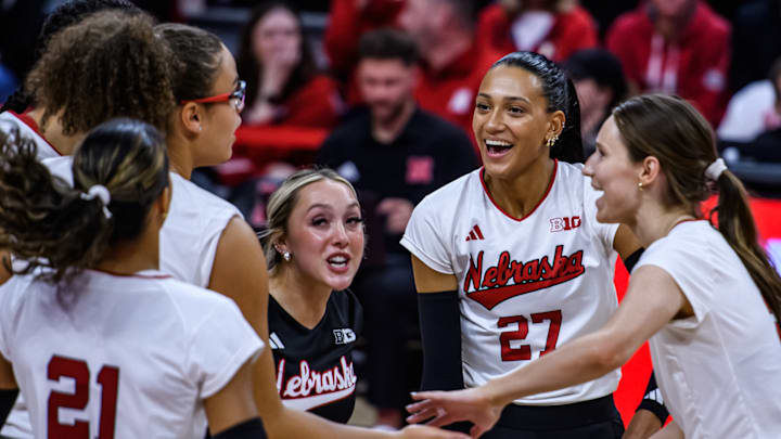 Harper Murray (27) smiles along with her teammates after the Huskers’ first point of the match. 