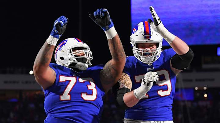 Buffalo Bills offensive tackle Dion Dawkins (73) and offensive tackle Spencer Brown (79) celebrate a touchdown against the New York Jets during the second half at Highmark Stadium. 