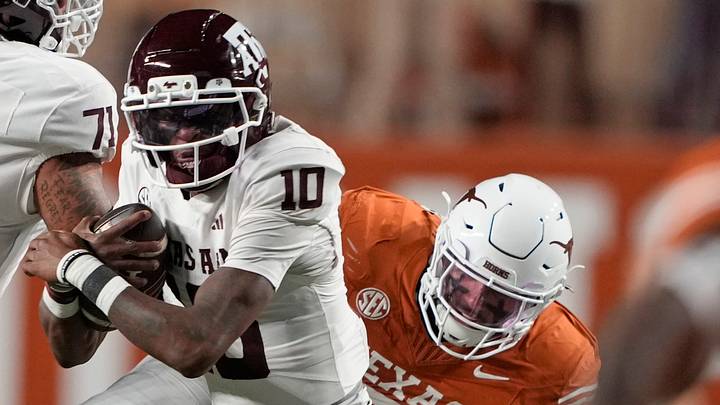 Texas A&M Aggies quarterback Marcel Reed keeps the ball for yardage before being tackled by Texas Longhorns linebacker Liona Lefau Texas A&M Aggies quarterback Marcel Reed keeps the ball for yardage before being tackled by Texas Longhorns linebacker Liona Lefau