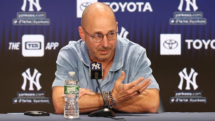 Aug 23, 2023; Bronx, New York, USA; New York Yankees general manager Brian Cashman talks with the