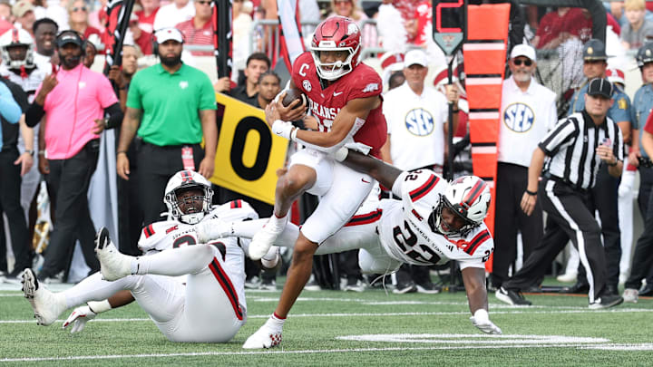 Sep 6, 2025; Little Rock, Arkansas, USA; Arkansas Razorbacks quarterback Taylor Green (10) rushes in the second quarter asArkansas State Red Wolves linebacker Nigel Nelson (22) defends at War Memorial Stadium. Mandatory Credit: Nelson Chenault-Imagn Images