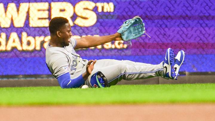 Apr 15, 2026; Milwaukee, Wisconsin, USA;  Toronto Blue Jays left fielder Jesus Sanchez (12) can't catch ball hit by Milwaukee Brewers designated hitter William Contreras (not pictured) for a single in the first inning at American Family Field. Mandatory Credit: Benny Sieu-Imagn Images