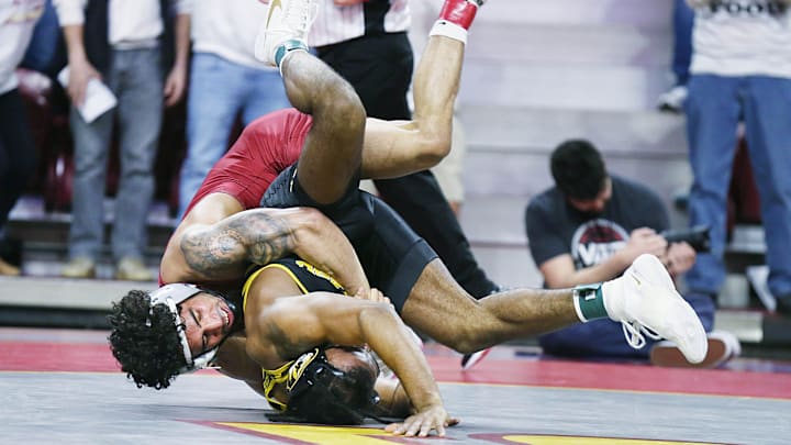 Iowa State Cyclones Anthony Echemendia takes down Missouri Tigers' Josh Edmond during their 141-pound wrestling in the Big-12-conference showdown at Hilton Coliseum on Sunday, Feb. 25, 2024, in Ames, Iowa Iowa State Cyclones Anthony Echemendia takes down Missouri Tigers' Josh Edmond during their 141-pound wrestling in the Big-12-conference showdown at Hilton Coliseum on Sunday, Feb. 25, 2024, in Ames, Iowa