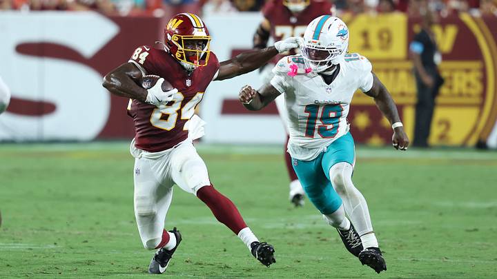 Washington Commanders wide receiver Jacoby Jones (84) runs with the ball as Miami Dolphins linebacker Kyle Louis (19) defends during the second half at Northwest Stadium. Washington Commanders wide receiver Jacoby Jones (84) runs with the ball as Miami Dolphins linebacker Kyle Louis (19) defends during the second half at Northwest Stadium.