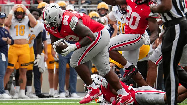 Ohio State Buckeyes defensive tackle Jamir Perez (98) scoops up a fumble and runs for a touchdown during the NCAA football game against the Kent State Golden Flashes at Ohio Stadium in Columbus on Sept. 19, 2026. Ohio State won 59-3.