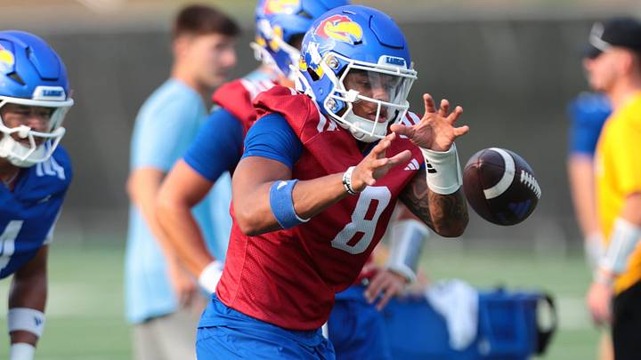 Kansas redshirt sophomore quarterback Isaiah Marshall (8) works on a drill during fall camp practice on Aug. 4, 2026.