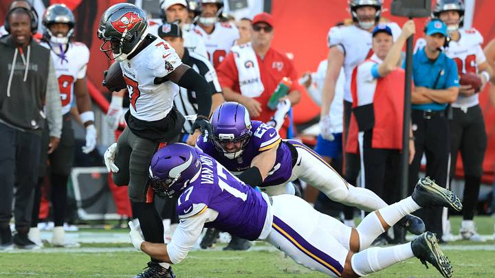 Sep 27, 2026; Tampa, Florida, USA;  Tampa Bay Buccaneers running back Bucky Irving (7) carries the ball defended by Minnesota Vikings linebacker Kyle Van Noy (17) and safety Harrison Smith (22) during the third quarter at Raymond James Stadium.  Mandatory Credit: Kim Klement Neitzel-Imagn Images