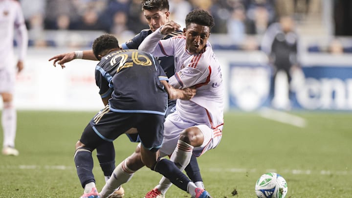 Apr 5, 2025; Chester, Pennsylvania, USA; Orlando City SC defender Alex Freeman (30) dribbles the ball against Philadelphia Union defender Nathan Harriel (26) during the second half at Subaru Park. Mandatory Credit: Luther Schlaifer-Imagn Images