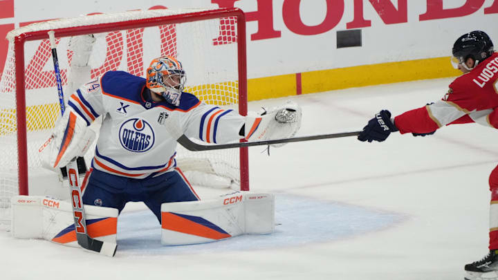 Jun 12, 2025; Sunrise, Florida, USA; Edmonton Oilers goaltender Stuart Skinner (74) blocks a shot by Florida Panthers forward Eetu Luostarinen (27) during the first period in game four of the 2025 Stanley Cup Final at Amerant Bank Arena. Mandatory Credit: Jim Rassol-Imagn Images Jun 12, 2025; Sunrise, Florida, USA; Edmonton Oilers goaltender Stuart Skinner (74) blocks a shot by Florida Panthers forward Eetu Luostarinen (27) during the first period in game four of the 2025 Stanley Cup Final at Amerant Bank Arena. Mandatory Credit: Jim Rassol-Imagn Images